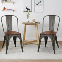 Load image into Gallery viewer, 4 stylish metal side chairs with wood seats that stack up for a café or dining area
